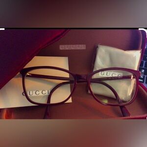 Gucci- Burgundy “Cat eye” glasses.